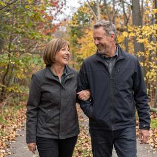 Diane and James, a MilaDate couple from Minneapolis, walking together on an autumn trail